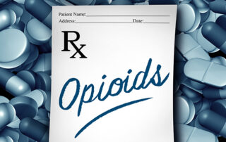 pharmacist prescription note pad laying on top of pills