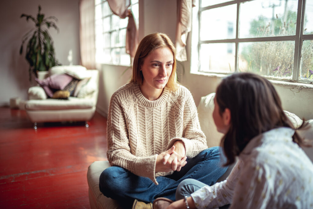 Mother and daughter having a talk. mother talking to teenage daughter at home