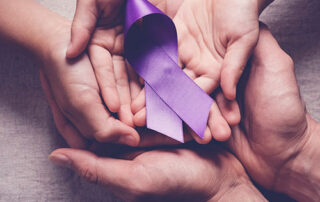 purple ribbon in hands